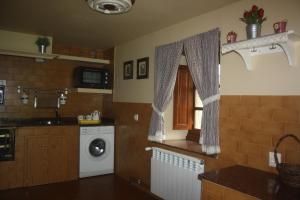 a kitchen with a washing machine and a window at Casa Lao I in El Pito