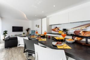 a dining room and living room with a table and chairs at Villa Valis in Baška