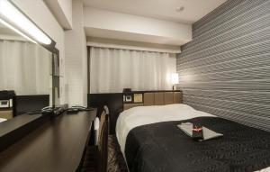 Ένα ή περισσότερα κρεβάτια σε δωμάτιο στο APA Hotel Fukushima Ekimae