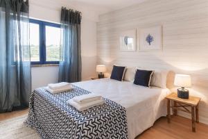 Ein Bett oder Betten in einem Zimmer der Unterkunft Apartamento Mar Salgado Ericeira