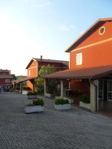 a group of buildings on a brick street at Fattoria Cerreto in Mosciano SantʼAngelo