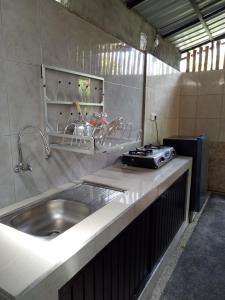 a kitchen with a sink and a counter top at Mulia Home Stay in Nusa Dua