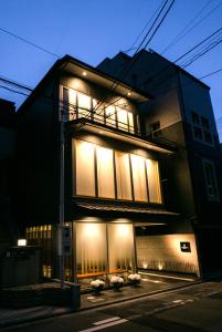 a building with lights on the side of it at Kyoto Kamanza Hotel in Kyoto