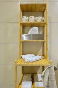 a wooden shelf with bowls and plates on it at Vacation House Tennoji 168, Osaka in Osaka +57 photos