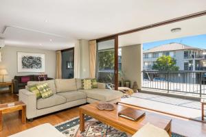 a living room with a couch and a table at Byron Bay Accom Unit 2 21-25 Fletcher Street - Casablanca at Bogarts in Byron Bay