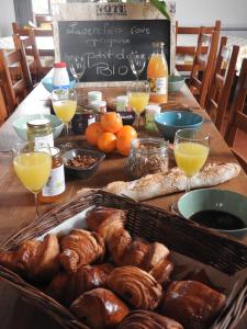 a table with a bunch of pastries and glasses of orange juice at Domaine de Laverchère in Pommiers-en-Forez