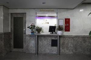 a reception counter in an office with flowers on it at Jeonju Hotel in Jeonju