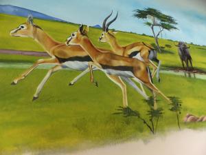 a painting of a group of gazelles in a field at Residence Maison Müge in Kilifi