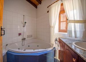 a bathroom with a tub and a sink at Linos Inn in Kakopetria