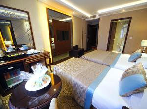 A bed or beds in a room at The Parma Hotel Downtown