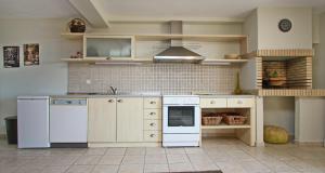 a kitchen with a white refrigerator and a stove at ELENA 3 in Kavála