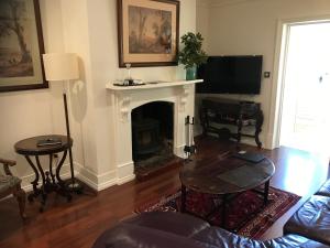 a living room with a fireplace and a tv at Barossa Shiraz Estate in Lyndoch