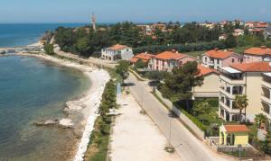 a view of a beach with houses and the ocean at Villa Julia in Lovrečica