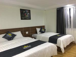 Postel nebo postele na pokoji v ubytování Queen Motel