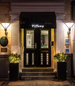 a front door of a thyme restaurant at night at Hotel Tiffany in Copenhagen