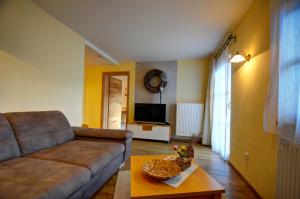 a living room with a couch and a table at Dienbergerhof 5 Sterne Ferienwohnungen in Untergriesbach