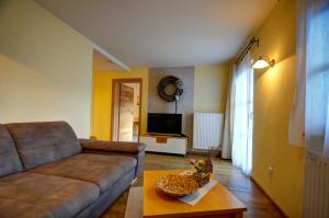 ein Wohnzimmer mit einem Sofa und einem Tisch in der Unterkunft Dienbergerhof 5 Sterne Ferienwohnungen in Untergriesbach