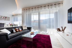 a living room with a couch and a glass table at Villa Valis in Baška