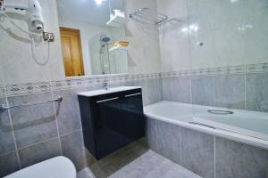 a bathroom with a tub and a sink and a shower at Posada Del Camino Real in Torrelaguna