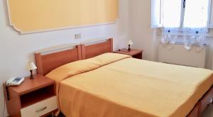 Letto o letti in una camera di Albergo Natucci
