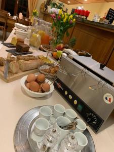 a breakfast table with eggs and bread on a counter at Auberge Communale à l'Union in Gilly