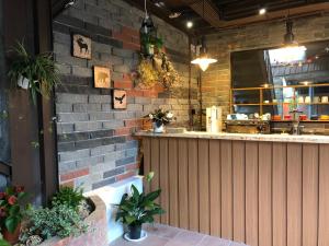 a restaurant with a brick wall and a bar at Yushow Library Villa in Nanzhuang +39 photos