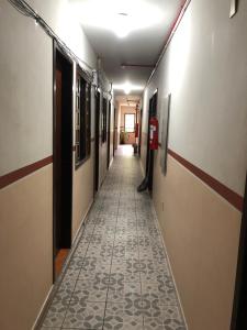 an empty hallway with a tile floor in a building at Hotel Vandressen e Castro in Garuva