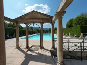 a gazebo with a pool in a yard at Historical castle in Montbrun les Bains with pool in Montbrun-les-Bains
