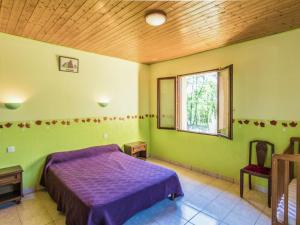 a bedroom with a purple bed and a window at Holiday home with swimming pool in Salignac