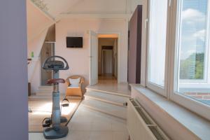 a room with a treadmill in front of a large window at Prachtig herenhuis uit 1925 in Nijlen