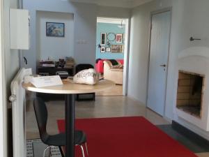 a room with a table with a chair and a living room at Fjällbacka Pensionat och Vandrarhem in Fjällbacka