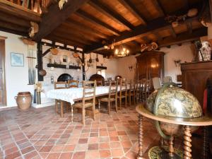 a large dining room with a table and chairs at Beautiful holiday home with heated pool in Villefranche-du-Périgord