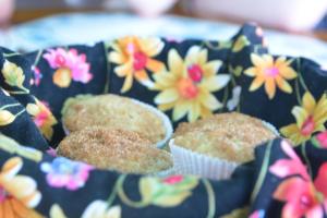 a bunch of muffins in a box with flowers at Treetops B & B Inn in San Juanillo