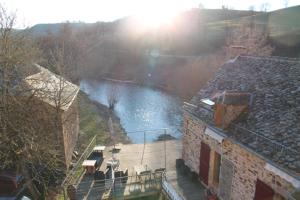 a view of a river from a building at Le Moulin de Benechou in Olemps