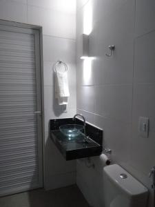 a bathroom with a sink and a toilet at Flats das Marias in Jequia da Praia