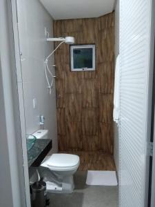 a bathroom with a toilet and a sink at Flats das Marias in Jequia da Praia