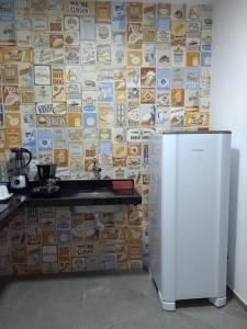 a kitchen with a wall covered in food magnets at Flats das Marias in Jequia da Praia