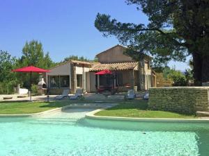 a house with a swimming pool in front of a house at Private infinity pool, beautiful view of Mont Ventoux, a dream spot! in Malaucène