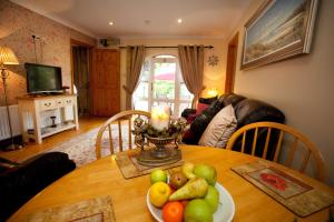 a dining room table with a plate of fruit on it at Evergreen Bed & Breakfast in Swords