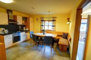 a kitchen with a table and chairs and a dining room at Dienbergerhof 5 Sterne Ferienwohnungen in Untergriesbach