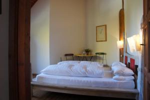 a bed with white sheets and pillows in a room at Naturata Hotel in Überlingen