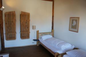 a bedroom with two beds and a mirror on the wall at Naturata Hotel in Überlingen