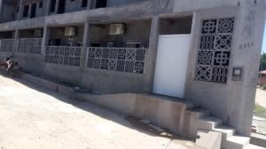 a building with a motorcycle parked in front of it at Flats das Marias in Jequia da Praia