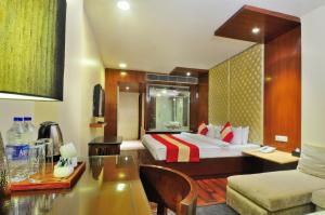 a hotel room with a bed and a table at Hotel Aura - New Delhi Railway Station in New Delhi