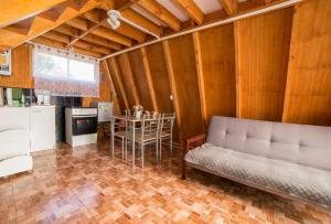 a living room with a couch and a table at Pyramidal Park Valdivia in Valdivia