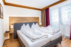 Łóżko lub łóżka w pokoju w obiekcie Hotel Unterhof