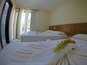 Postel nebo postele na pokoji v ubytování Aquaville Apart Hotel