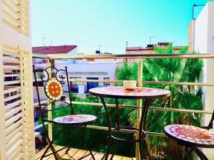 a balcony with two tables and chairs on a balcony at Privat Hotel Liberty Sitges in Sitges