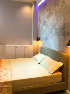 a small bedroom with a bed with lights on it at Europa Apartment in Tirana