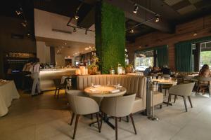 a restaurant with tables and chairs and a green wall at Hotel St. Michel in Miami